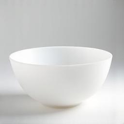 Frosted clear quartz crystal singing bowl on a white surface, bathed in soft light.