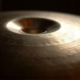 Close-up of a handpan in C-major, showing the central ding and radiating tone fields with subtle reflections.